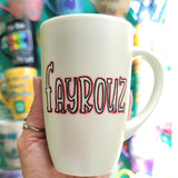 A hand painted pearl  white mug with the name 