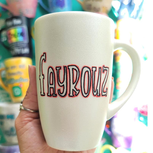 A hand painted pearl  white mug with the name "fayrouz"