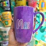 A hand-painted purple galaxy mug with the name 