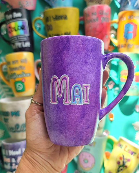 A hand-painted purple galaxy mug with the name "Mai"