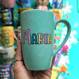 A Pastel green Hand-painted mug with the name 