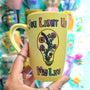 A Pastel yellow hand-painted mug with the words "you light up my life" and a bulb drawn on it with flowers inside