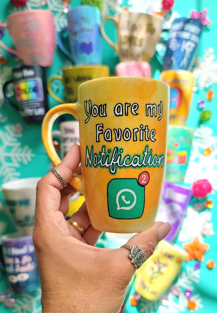 A yellow orange hand-painted mug with the words "You are my favorite notification"