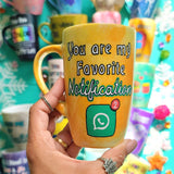 A yellow orange hand-painted mug with the words 