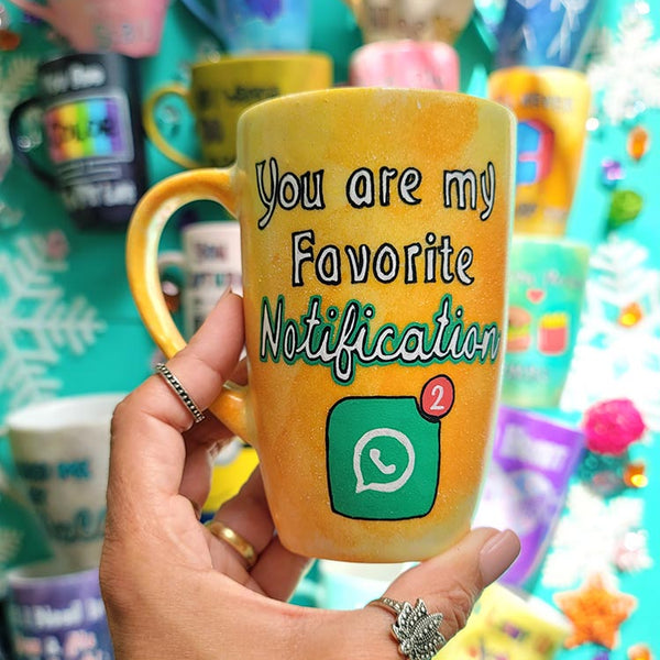 A yellow orange hand-painted mug with the words "You are my favorite notification"