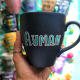 A shimmery blue hand painted mug with the name 