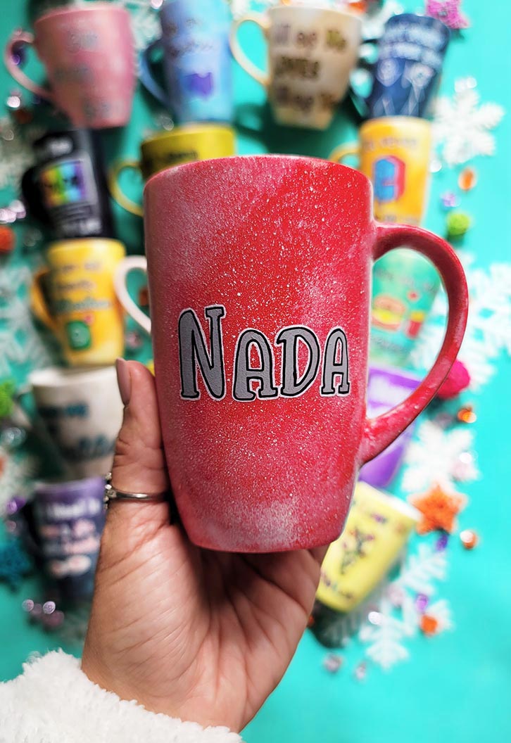 A hand-painted red galaxy mug with the name "Nada"