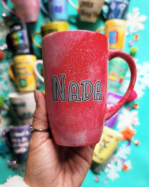 A hand-painted red galaxy mug with the name "Nada"