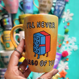 A yellow orange hand-painted mug with the words 