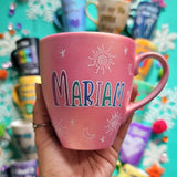 A shimmery pink hand painted mug with the name 