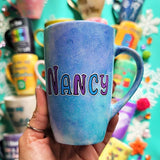 A hand-painted  light blue purple mug with the name 