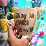 A hand-painted goldish mug with the words 