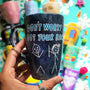 A hand painted black galaxy mug with the words "don't worry, I got your back " and a drawing of 2 stick figures with the girl holding the back of the boy