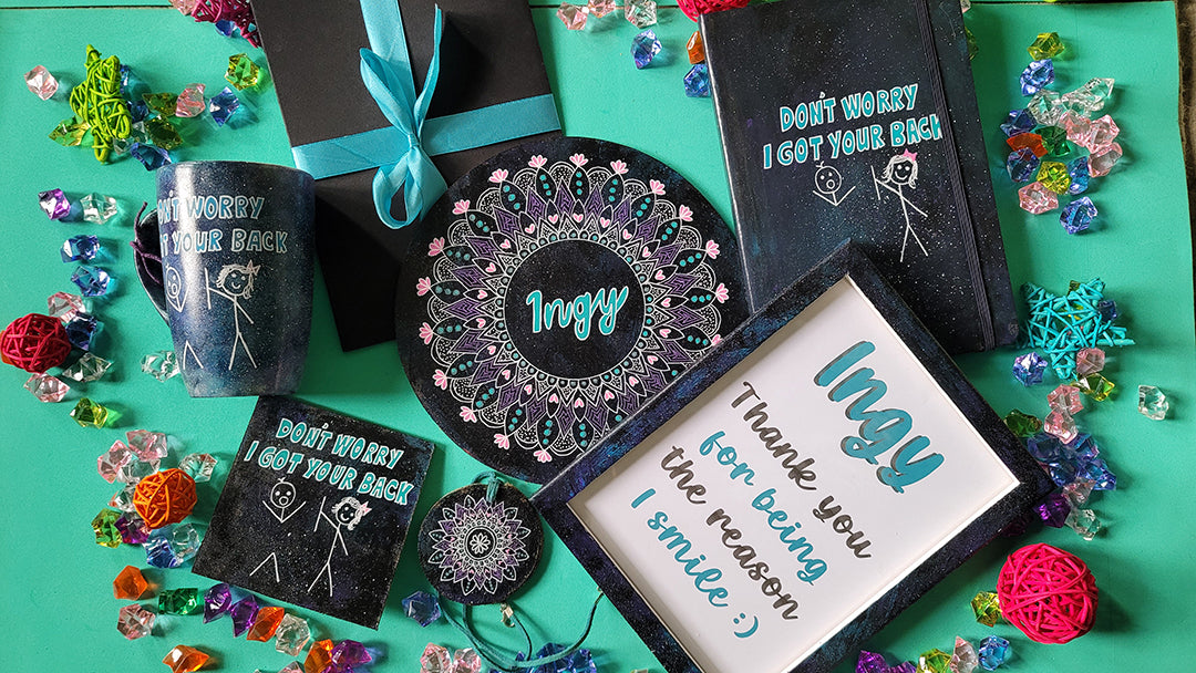 A Gift Set hand painted in black galaxy containing mug, notebook, coaster, mdf plate, tree pendant, wood frame and card all with the name Ingy and I got your back with a boy and girl stick figure and the girl holding the line back of the boy