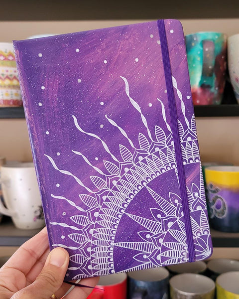 A Purple Galaxy hand painted notebook with a quarter mandala drawn from the corner