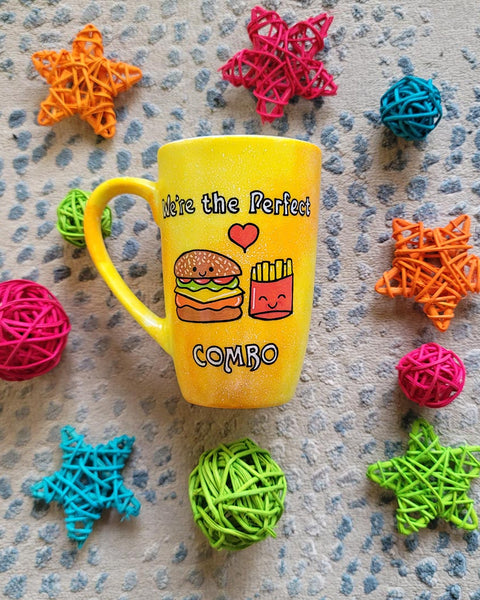 A hand-painted yellow orange mug with the words "we're the perfect combo"