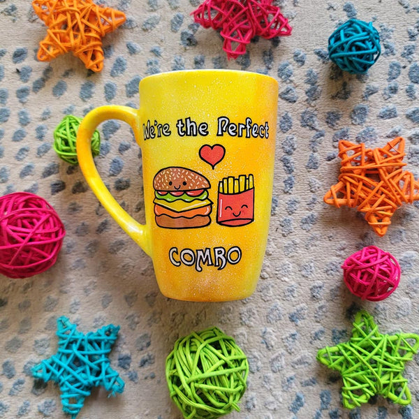 A hand-painted yellow orange mug with the words "we're the perfect combo"