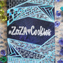 A Bluish galaxy hand painted notebook with patterns on the top and bottom and the words "Zoza heart Cookies" is written