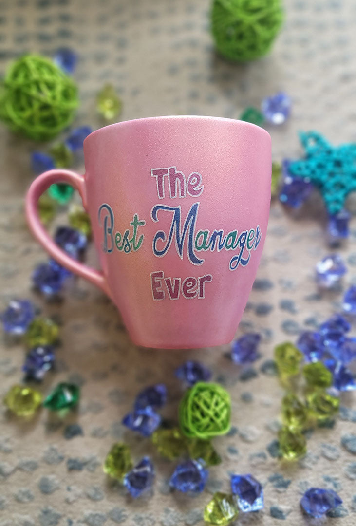 A Shimmery pink hand painted mug with the words "The Best Manager Ever"