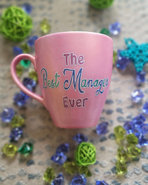 A Shimmery pink hand painted mug with the words "The Best Manager Ever"