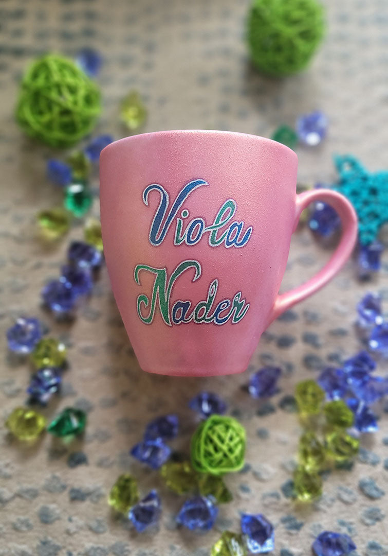 A Shimmery pink hand painted mug with the name "Viola Nader"