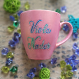 A Shimmery pink hand painted mug with the name 