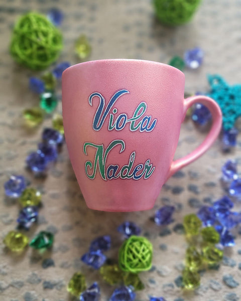 A Shimmery pink hand painted mug with the name "Viola Nader"