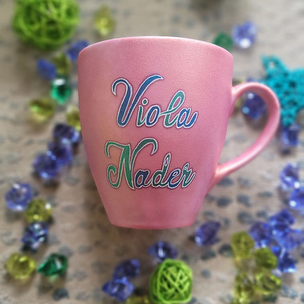 A Shimmery pink hand painted mug with the name "Viola Nader"