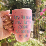 A hand-painted shimmery pink mug with the words 