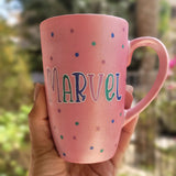 A hand-painted shimmery pink mug with the name 