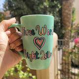 A Hand painted green Mug with the words 