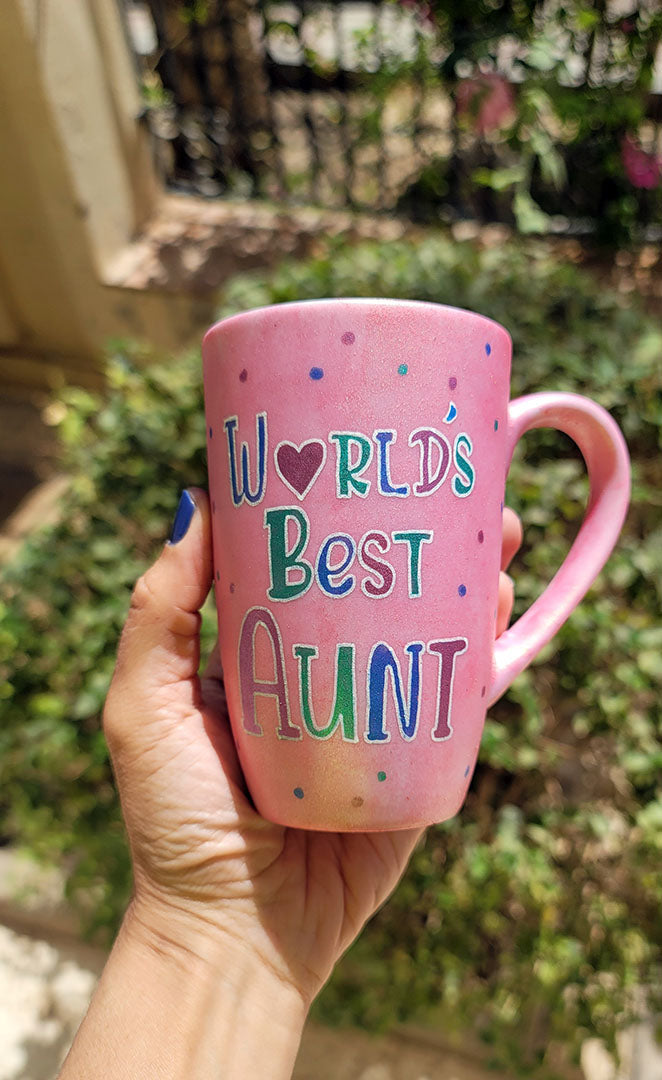 A Shimmery Pink hand painted mug with the words "Worlds Best Aunt"