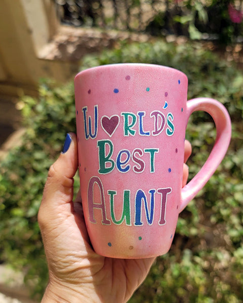 A Shimmery Pink hand painted mug with the words "Worlds Best Aunt"