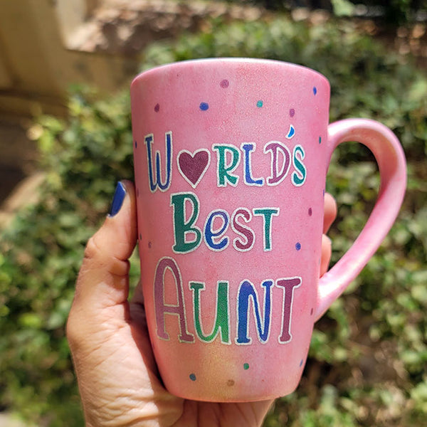 A Shimmery Pink hand painted mug with the words "Worlds Best Aunt"