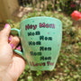 A mint Colored mug with the sentence "Hey mom mom mom mom mom mom I love you" with white and green dots and pink stars scattered all over