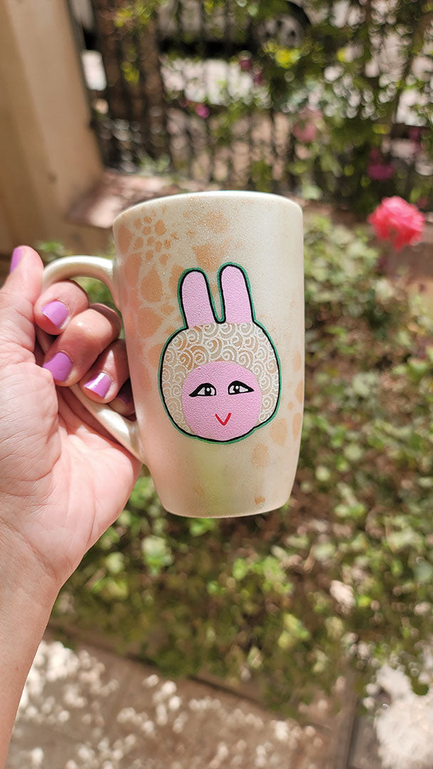 A Shimmery White with gold islamic patterns hand painted mug with tamtam on it in patterns