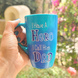 A blue handpainted mug with the words 