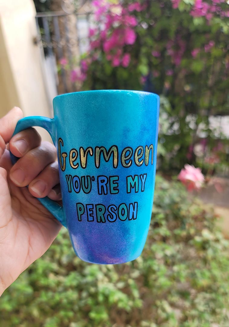 A Hand painted blue mug with the words "Germeen, you're my person"