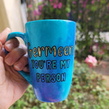 A Hand painted blue mug with the words 