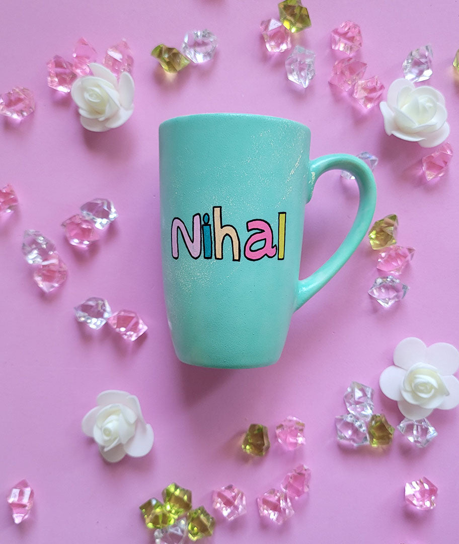 A Mint green hand painted mug with the name "Nihal"