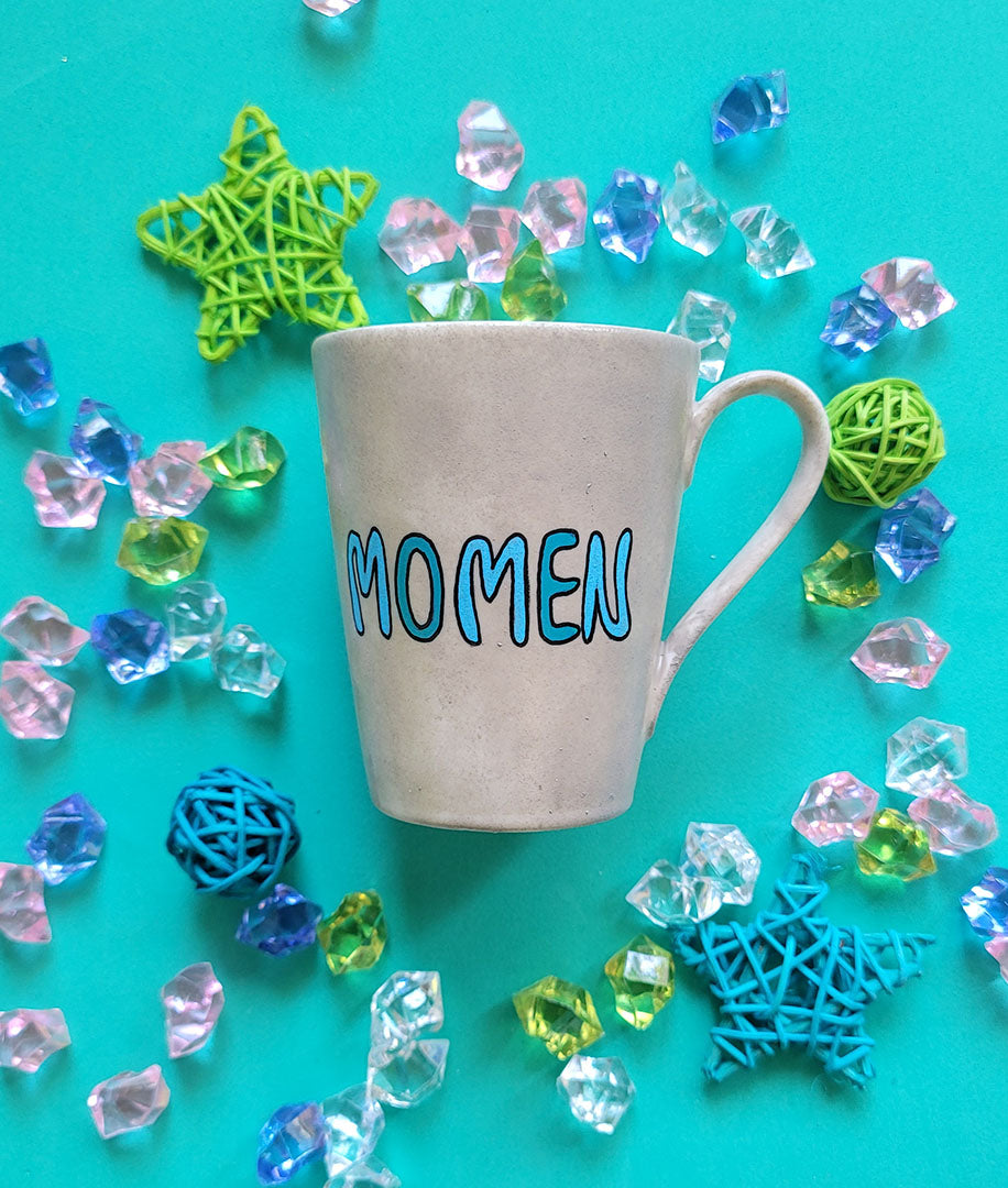 A Taupe hand painted mug with the name "Momen"