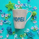 A Taupe hand painted mug with the name 