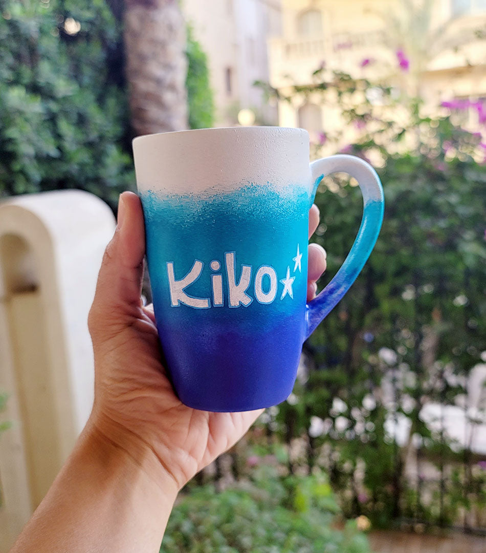 A Gradient hand painted mug with the colors (White turquoise and ultramarine) with the name "Kiko""