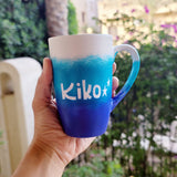 A Gradient hand painted mug with the colors (White turquoise and ultramarine) with the name 