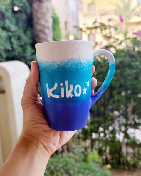 A Gradient hand painted mug with the colors (White turquoise and ultramarine) with the name "Kiko""