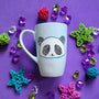 A baby blue hand painted mug with a panda face in zentangles on it