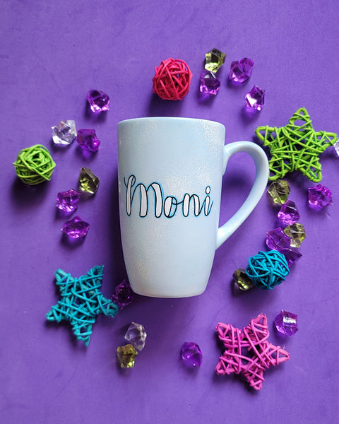 A baby blue hand painted mug with the name "Moni"