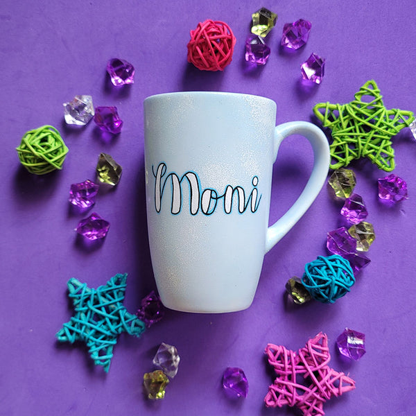 A baby blue hand painted mug with the name "Moni"