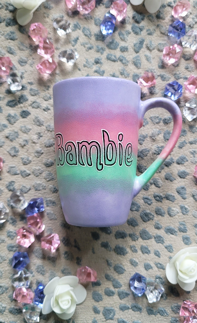 A gradient hand painted mug (lilac-pink-mint-lilac) with the word Bambie written