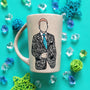 A taupe hand painted mug with a silhouette of a man in a suit filled with patterns